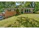 Charming brick home with well-manicured lawn and inviting front porch at 1302 N Furman Ave, Indianapolis, IN 46214
