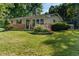 Well-maintained home featuring beautiful landscaping and a welcoming entrance at 1302 N Furman Ave, Indianapolis, IN 46214