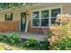 Close-up of the charming front porch with flowers, decor and sitting area at 1302 N Furman Ave, Indianapolis, IN 46214
