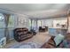 This open living room is adjacent to the dining area, with neutral tones and natural light at 1302 N Furman Ave, Indianapolis, IN 46214