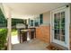 Charming covered porch featuring a bistro table, cozy seating, and a welcoming entrance at 1302 N Furman Ave, Indianapolis, IN 46214