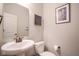 Powder room featuring pedestal sink, toilet, and decorative art on the neutral toned walls at 16235 Natures Way, Westfield, IN 46074