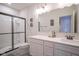 Well-lit bathroom featuring a glass-enclosed shower and a double sink vanity with modern fixtures at 16235 Natures Way, Westfield, IN 46074