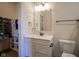 Well-lit bathroom showcasing a vanity with a quartz countertop and a walk-in closet at 16235 Natures Way, Westfield, IN 46074