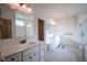 Bright bathroom with double vanities, patterned floor tiles, and glass-enclosed shower for a spa-like experience at 16235 Natures Way, Westfield, IN 46074
