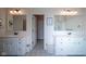 Bathroom featuring double vanities, modern fixtures, and decorative floor tiles for a touch of elegance at 16235 Natures Way, Westfield, IN 46074