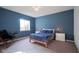 Comfortable bedroom featuring a large window, neutral carpet, and a statement blue accent wall at 16235 Natures Way, Westfield, IN 46074