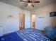 Charming bedroom featuring a unique blue patterned rug, ceiling fan, and ensuite bathroom and closet entrances at 16235 Natures Way, Westfield, IN 46074