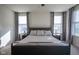Comfortable bedroom with a large bed, neutral bedding, ceiling fan, and windows allowing natural light at 16235 Natures Way, Westfield, IN 46074