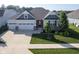 Charming home with a well-manicured lawn, two-car garage, and stylish architectural details at 16235 Natures Way, Westfield, IN 46074