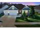 Charming home with a well-manicured lawn, two-car garage, and stylish architectural details at dusk at 16235 Natures Way, Westfield, IN 46074