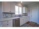 Kitchen featuring white cabinets, stainless steel dishwasher, and decorative backsplash at 16235 Natures Way, Westfield, IN 46074
