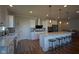Modern kitchen with an island, stainless steel appliances, white cabinets, and pendant lighting at 16235 Natures Way, Westfield, IN 46074