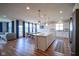 Open-concept kitchen featuring an island, dining table, modern lighting, and sleek appliances at 16235 Natures Way, Westfield, IN 46074