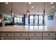Bright kitchen with island opens to living space, featuring elegant lighting and countertops at 16235 Natures Way, Westfield, IN 46074