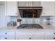 Close up of a kitchen featuring a stovetop, stainless steel appliances, and decorative backsplash at 16235 Natures Way, Westfield, IN 46074
