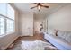 Bright living room with hardwood floors, a ceiling fan, and large windows providing ample natural light at 16235 Natures Way, Westfield, IN 46074