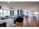 Spacious living room with hardwood floors, large windows, comfortable seating, and dining area at 16235 Natures Way, Westfield, IN 46074