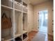 Mudroom featuring built-in shelving with storage bins, a door to the garage, and durable flooring at 16235 Natures Way, Westfield, IN 46074