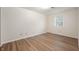 A cozy bedroom with wood-look floors, light walls, and a bright window at 2009 N New York Ave, Muncie, IN 47304