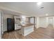 Open kitchen features white cabinetry, an island with wood countertop, and stainless steel appliances at 2009 N New York Ave, Muncie, IN 47304