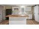 Kitchen features island with butcher block countertop, stainless appliances, and white cabinets at 2009 N New York Ave, Muncie, IN 47304