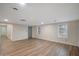 Spacious living room boasts wood floors, recessed lighting, and multiple windows at 2009 N New York Ave, Muncie, IN 47304