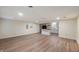 Open concept living room features wood-look floors, recessed lighting, and kitchen bar at 2009 N New York Ave, Muncie, IN 47304