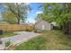 Backyard featuring green grass, a patio area, and a detached garage at 2026 E 10Th St, Indianapolis, IN 46201
