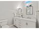 Bright bathroom featuring a double vanity, stylish lighting, and neutral tiling at 2026 E 10Th St, Indianapolis, IN 46201