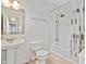 Bathroom featuring a pedestal sink, updated fixtures, and a tub with shower at 2026 E 10Th St, Indianapolis, IN 46201