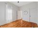 Bedroom featuring hardwood floors, neutral walls, and a sun-filled window with sheer curtains at 2026 E 10Th St, Indianapolis, IN 46201