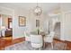The dining room features a round glass table, seating for four, and a modern globe chandelier at 2026 E 10Th St, Indianapolis, IN 46201