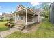 Inviting home showcasing a large front porch, neat landscaping, and a cozy, welcoming facade at 2026 E 10Th St, Indianapolis, IN 46201