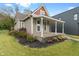 Attractive home with a spacious covered porch, well-maintained landscaping, and inviting entrance at 2026 E 10Th St, Indianapolis, IN 46201