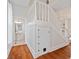 Hallway area with stairs and bathroom view featuring hardwood floors and bright lighting at 2026 E 10Th St, Indianapolis, IN 46201