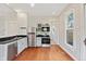 A bright kitchen offers hardwood floors, light grey cabinetry, and stainless appliances at 2026 E 10Th St, Indianapolis, IN 46201