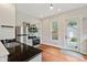 Compact kitchen features modern appliances, light gray cabinetry, and hardwood floors at 2026 E 10Th St, Indianapolis, IN 46201