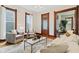 Cozy living room with a glass coffee table, neutral-toned furniture, and warm hardwood floors at 2026 E 10Th St, Indianapolis, IN 46201
