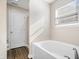 Bathroom with tub, shower, and a large window provides a bright and airy space at 216 Haywood Rd, Greenwood, IN 46142