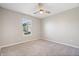 Carpeted bedroom with a window and ceiling fan offers a comfortable and relaxing atmosphere at 216 Haywood Rd, Greenwood, IN 46142