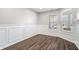 Bright bedroom features wood floors, wainscoting, and a bay window for ample natural light at 216 Haywood Rd, Greenwood, IN 46142