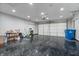 Spacious garage with epoxy flooring, ample lighting, and an automatic door enhances functionality at 216 Haywood Rd, Greenwood, IN 46142