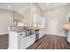 Modern kitchen with white cabinetry, stainless steel appliances, granite countertops and luxury vinyl plank flooring at 216 Haywood Rd, Greenwood, IN 46142