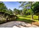 View of the property's backyard with lush greenery and a retaining wall feature at 2247 Frisco Pl, Indianapolis, IN 46240