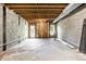 Unfinished basement area showcasing concrete foundation, exposed ceiling joists and a walkout to the backyard at 2247 Frisco Pl, Indianapolis, IN 46240