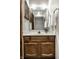Bathroom featuring a wooden vanity, a large mirror, and ample lighting for grooming at 2247 Frisco Pl, Indianapolis, IN 46240