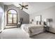 Bedroom with vaulted ceiling, arched window, ceiling fan, and neutral decor at 2247 Frisco Pl, Indianapolis, IN 46240