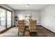 Bright dining area features a glass table, four wicker chairs, and sliding door access to outdoor space at 2247 Frisco Pl, Indianapolis, IN 46240