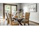 Dining room boasts glass table, wicker chairs, and sliding doors offering natural light and outdoor view at 2247 Frisco Pl, Indianapolis, IN 46240
